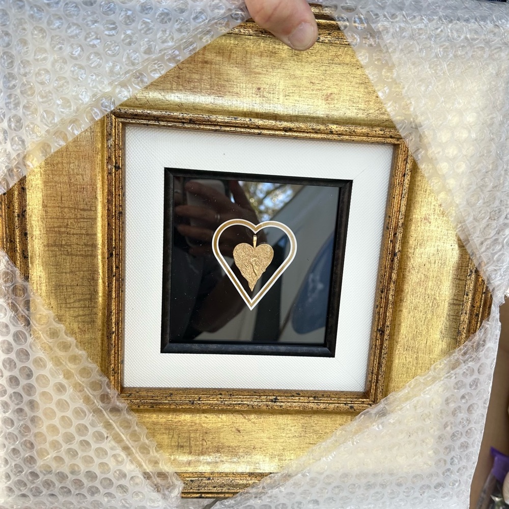 Erte heart with black cord beautifully framed.